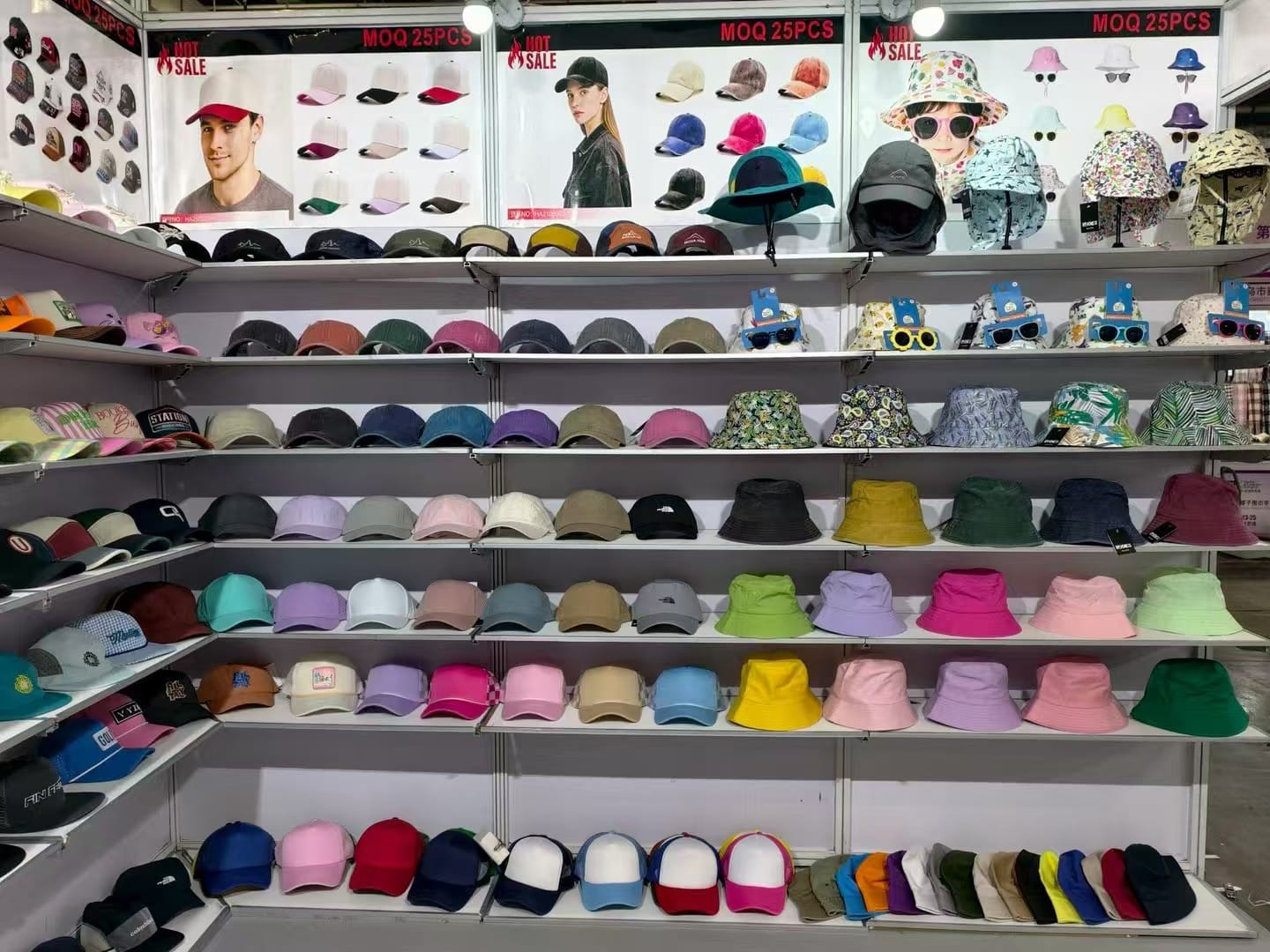 Trade show display featuring bucket hats and trucker caps